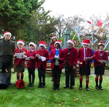 A jolly good time! Kingston Vale care home welcomes school choir for a festive sing-along