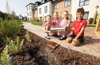 Back to the future! Cardiff care home welcomes pupils to bury time capsule