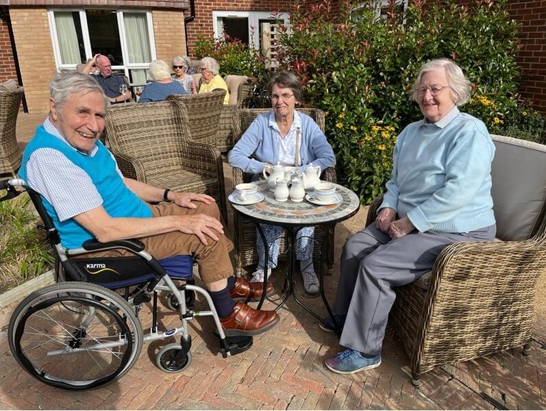 Team Leader Care Bank - Martlet Manor residents in garden 