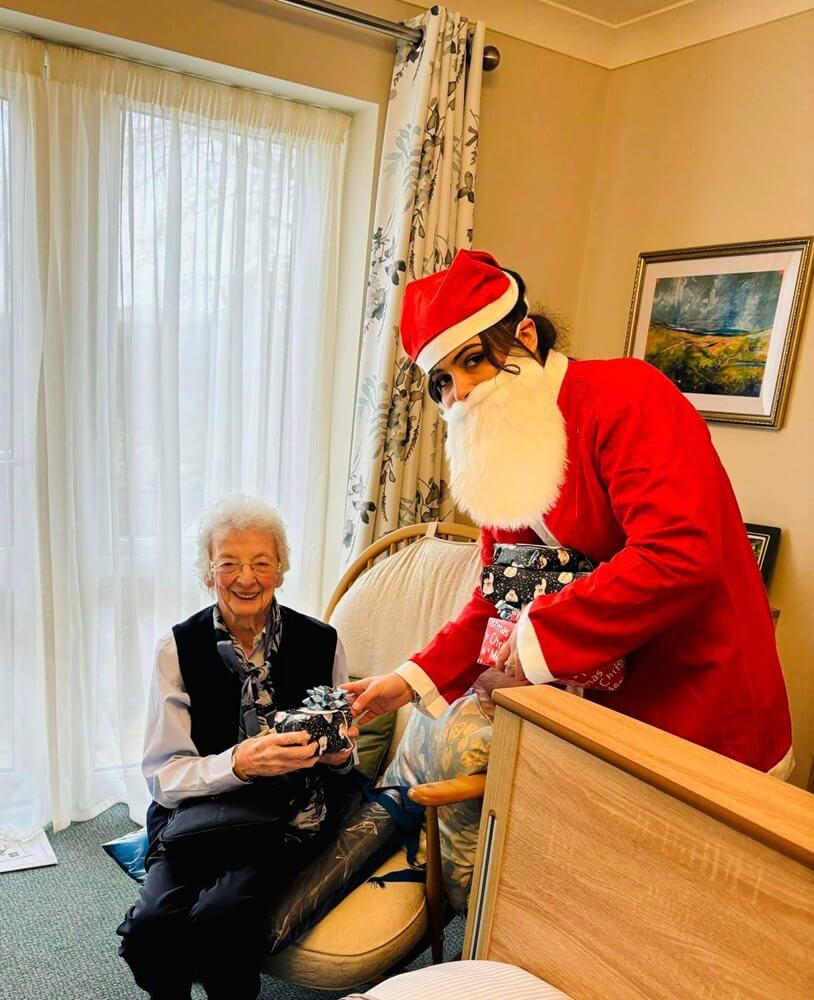 Care Assistant - Cuttlebrook Santa giving residents christmas presents