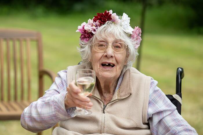 A resident at Sway Place enjoying a glass of wine at the homes festival