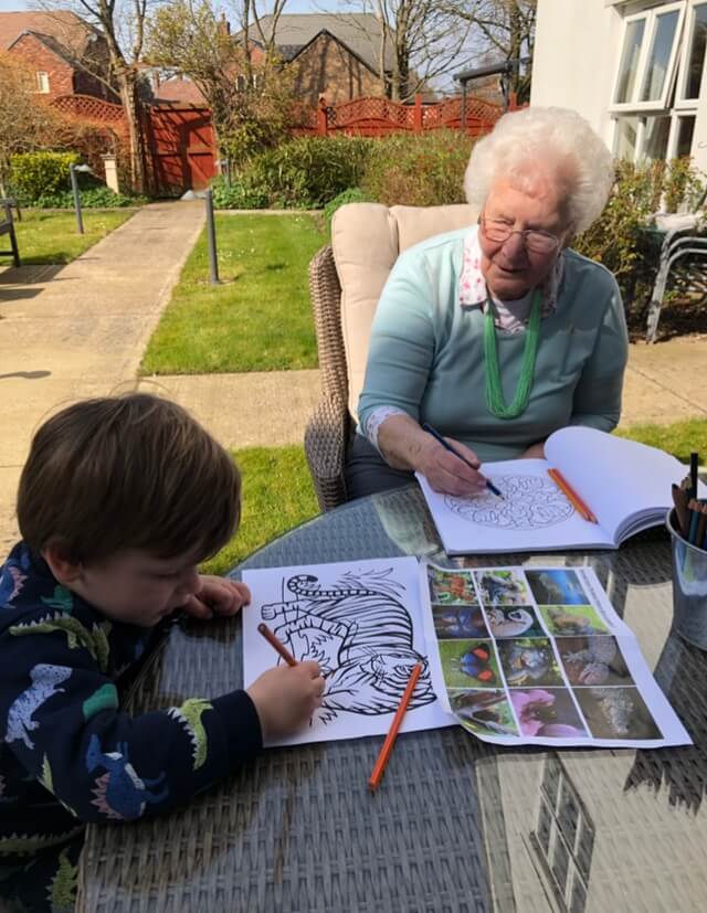 Blossomfield Grange resident Sylvia enjoys drawing with her great grandson.